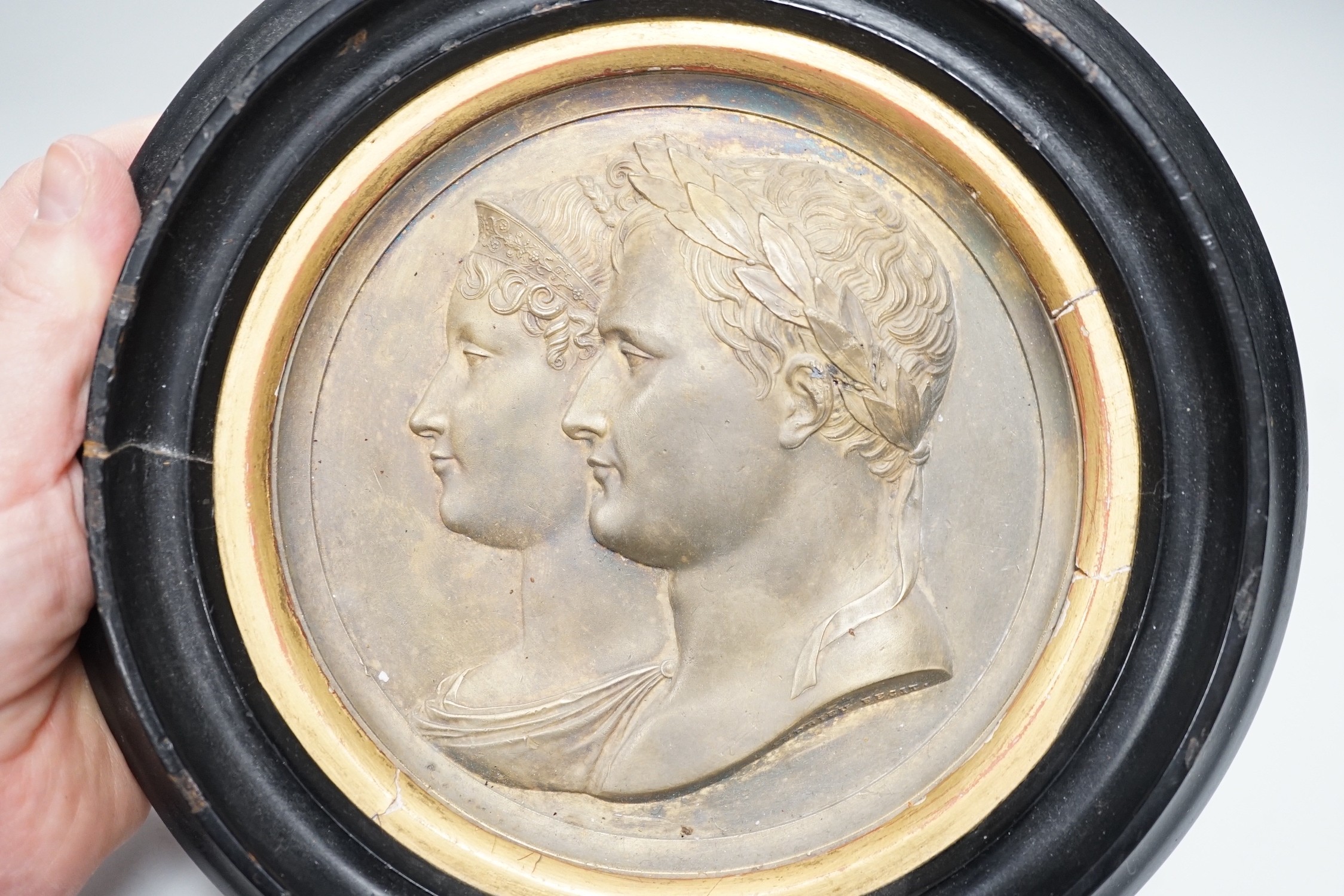 After Bertrand Andrieu (1761-1822). A framed circular gilt brass relief plaque of Napoleon Bonaparte and Marie Louise, Duchess of Parma: signed lower right of bust 'Andrieu Fecit', 14cm diameter excl frame